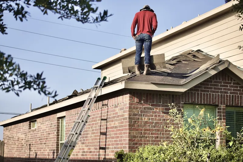 Professional roofer working on a residential roof in Sedgefield Acres